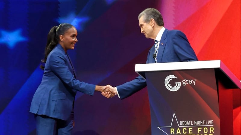 Keisha Lance Bottoms and Rick Jackson shake hands after the ANF, Gray Media debate on Tuesday,...