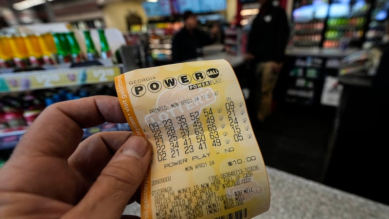 In this file photo, a Powerball lottery ticket is seen at a grocery store on April 1, 2024, in...