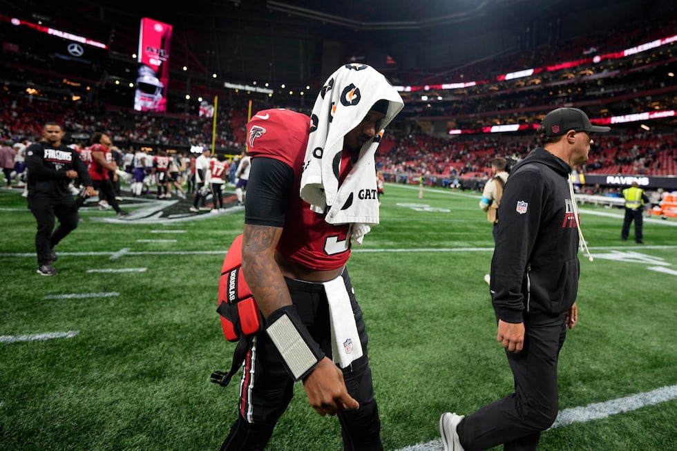 Atlanta Falcons quarterback Michael Penix Jr. walks off the field after a NFL football game...