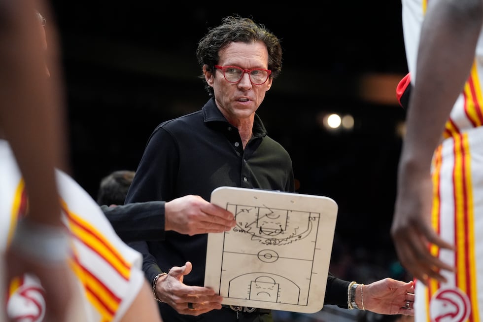 Atlanta Hawks head coach Quin Snyder talks to his team before an NBA basketball game against...