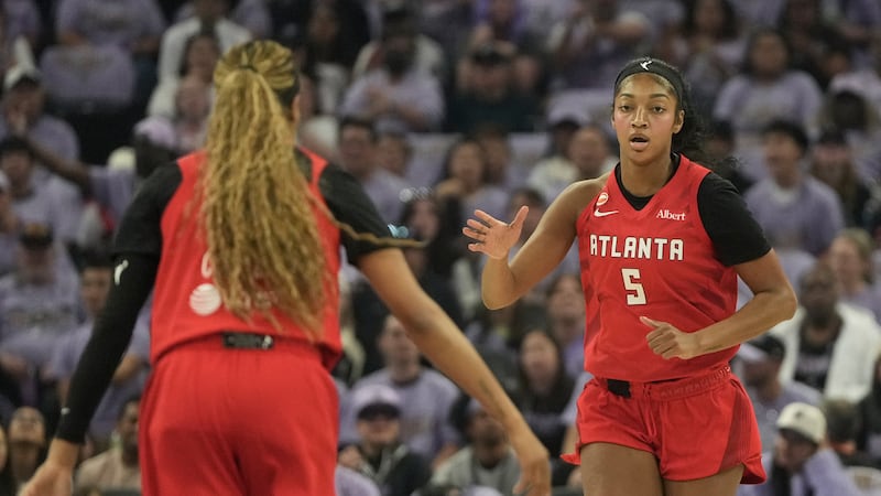 Atlanta Dream forward Angel Reese (5) is congratulated by guard Jordin Canada after scoring...