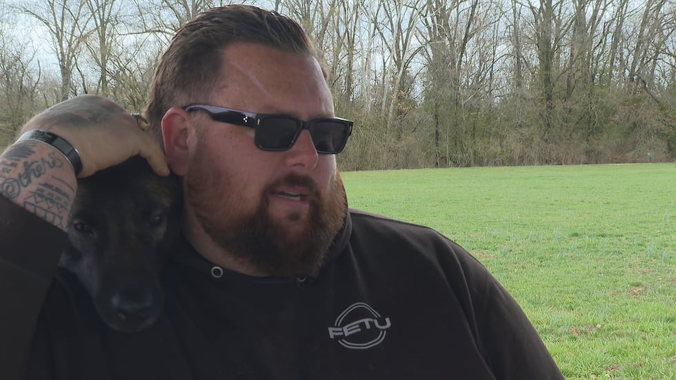Andy Moulton pets K-9 Viktor during an interview with First Alert 4 Investigates. Moulton...