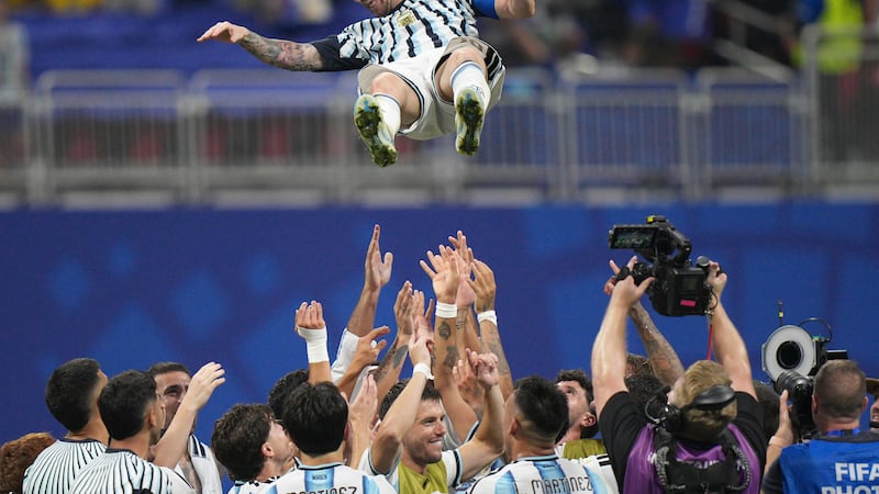 Argentina players toss teammate Lionel Messi (10) into the air as they celebrate after the...