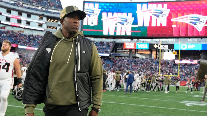 Atlanta Falcons head coach Raheem Morris leaves the field after an NFL football game against...