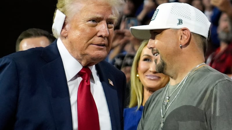 Republican presidential candidate former President Donald Trump greets country music singer...