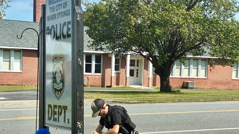 A memorial sits outside the Warm Springs Police Department for Sgt. Chris Fisher, who was...