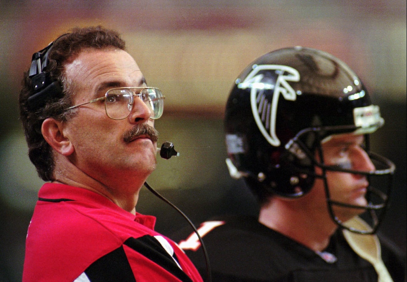 Atlanta Falcons head coach June Jones watches the clock while standing on the sidelines with quarterback Jeff George (1) during the game against the St. Louis Rams Sunday, Nov. 19, 1995. (JOHN BAZEMORE | ASSOCIATED PRESS)