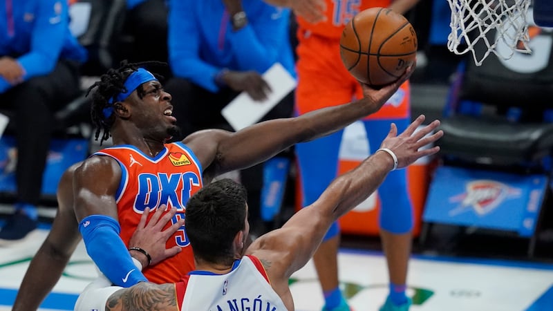 FILE - Oklahoma City Thunder forward Luguentz Dort, left, goes up for a shot in front of New...