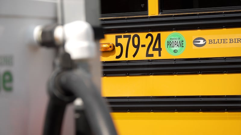 A propane bus sits behind a pump in Marietta, Ga.