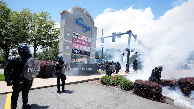 Police break up a crowd during a "No Kings" protest in Dekalb County, near Atlanta, Saturday,...