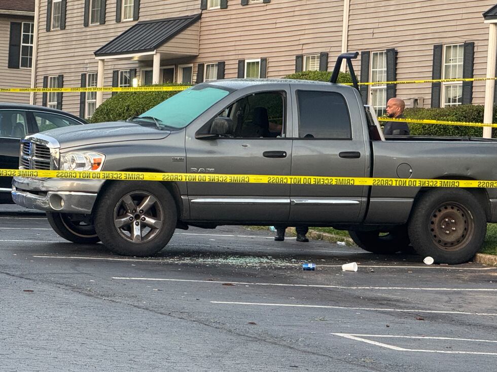South Fulton police inspect a car riddled with bullet holes after an apartment complex shooting.